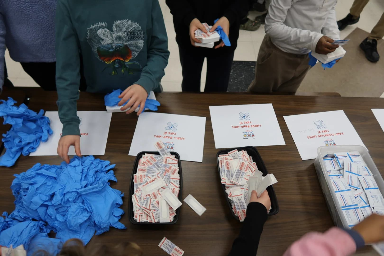 Students assembling care kits at tables during the workshop