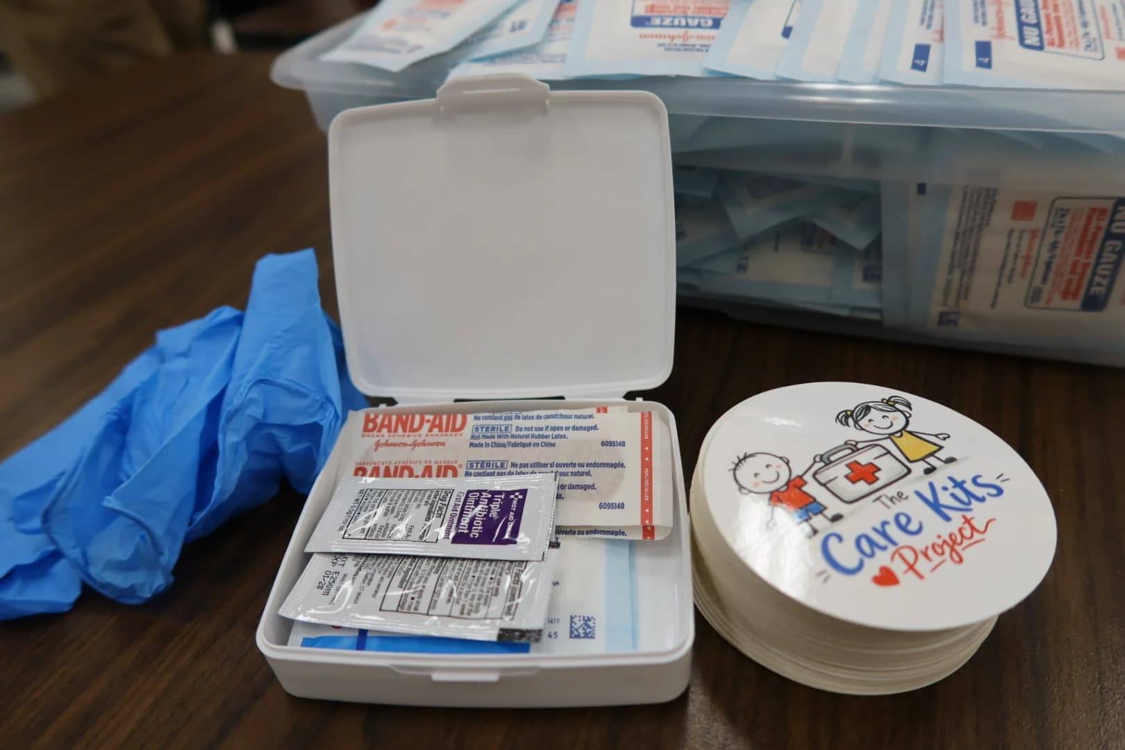 Care Kit contents, bandages, antibiotic ointment, gloves inside a branded kit