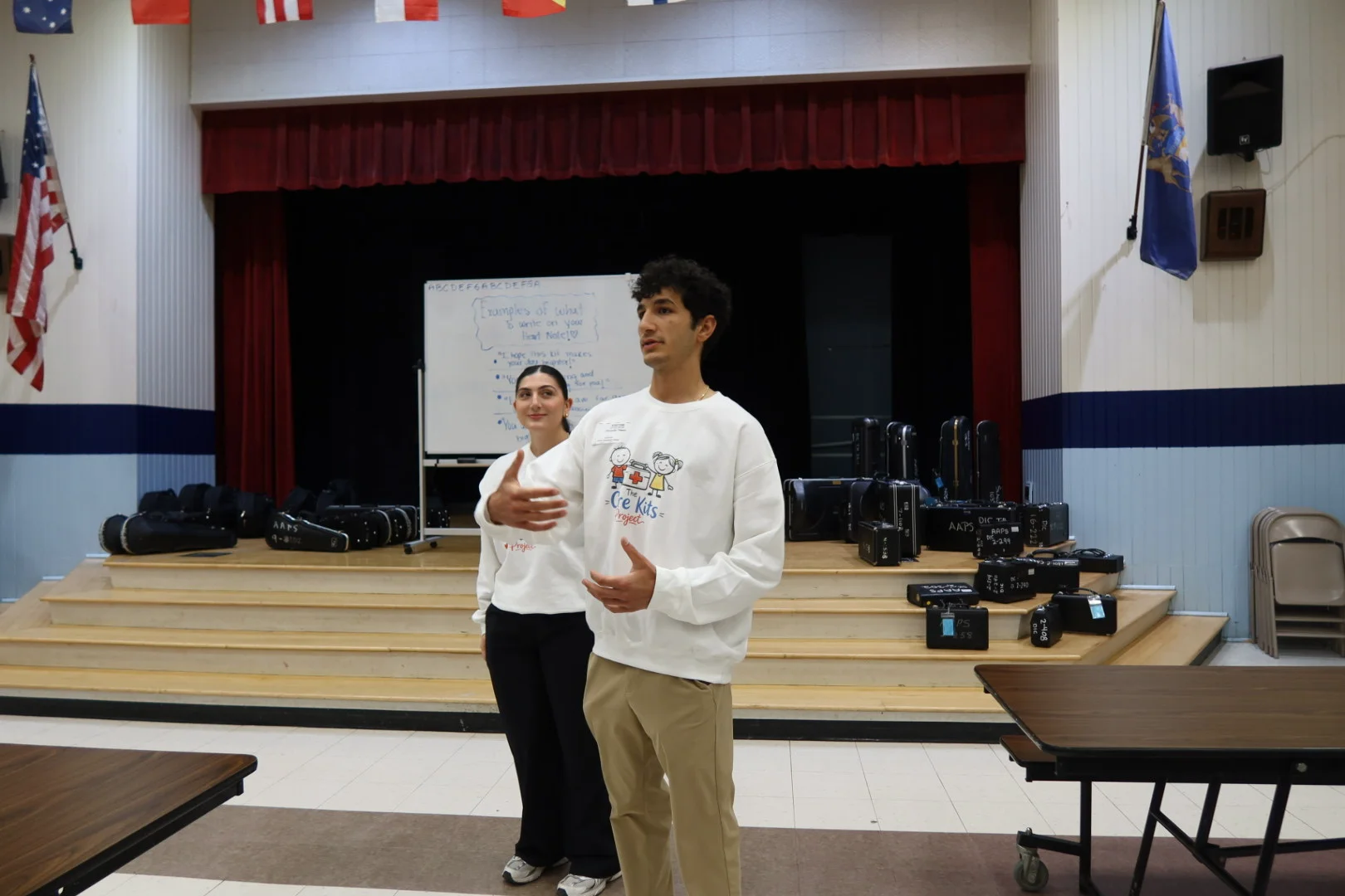 Alexander and Lilyana presenting at Dicken Elementary in Care Kits Project crewnecks