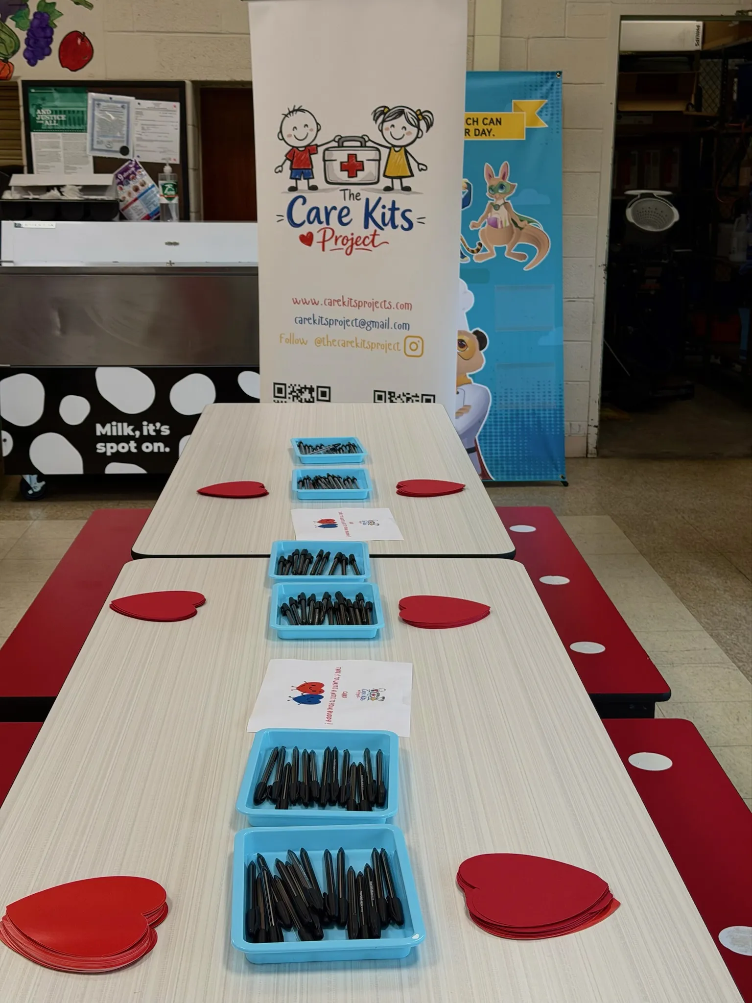 Workshop tables set with markers and heart notes before students arrive
